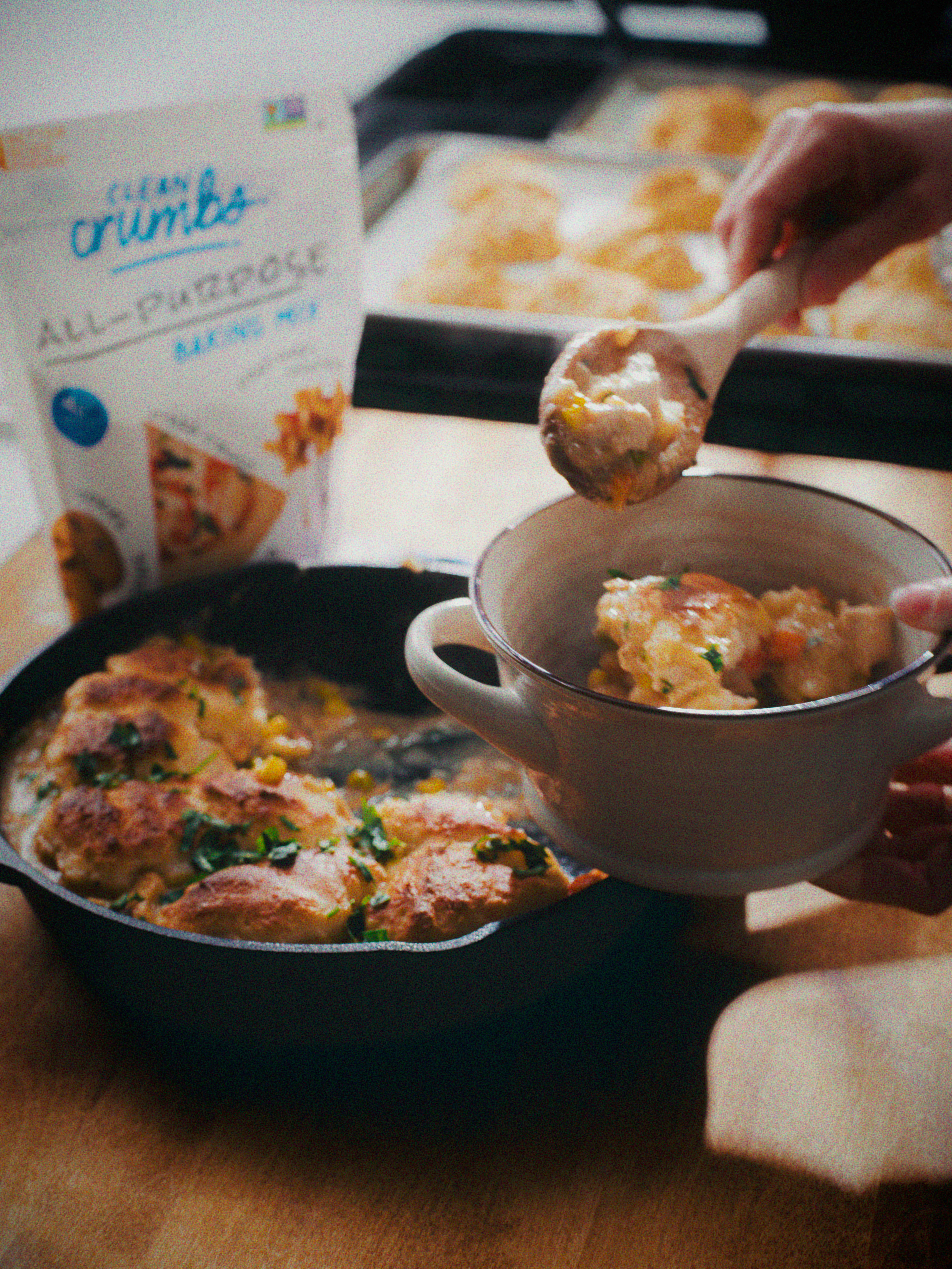 Chicken pot pie filling being served from a skillet